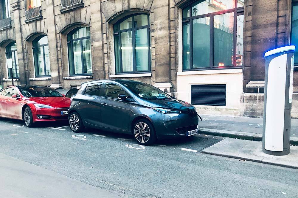 Renault ZOE стоит на зарядке на бесплатной парковке для электромобилей