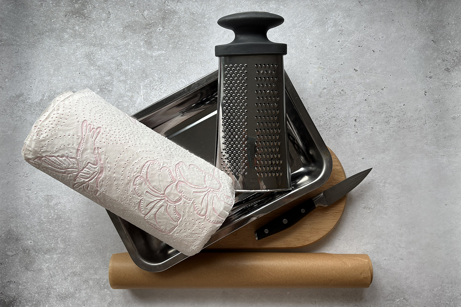 Из инвентаря понадобится противень или металлическая форма для запекания, бумага для выпечки, мелкая терка и бумажные полотенца