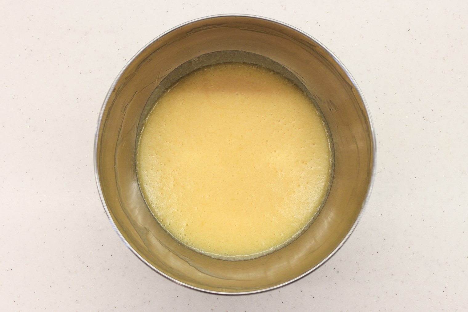 Шаг 2. Яйца с сахаром взбейте венчиком до однородности. Добавьте растопленное масло, перемешайте