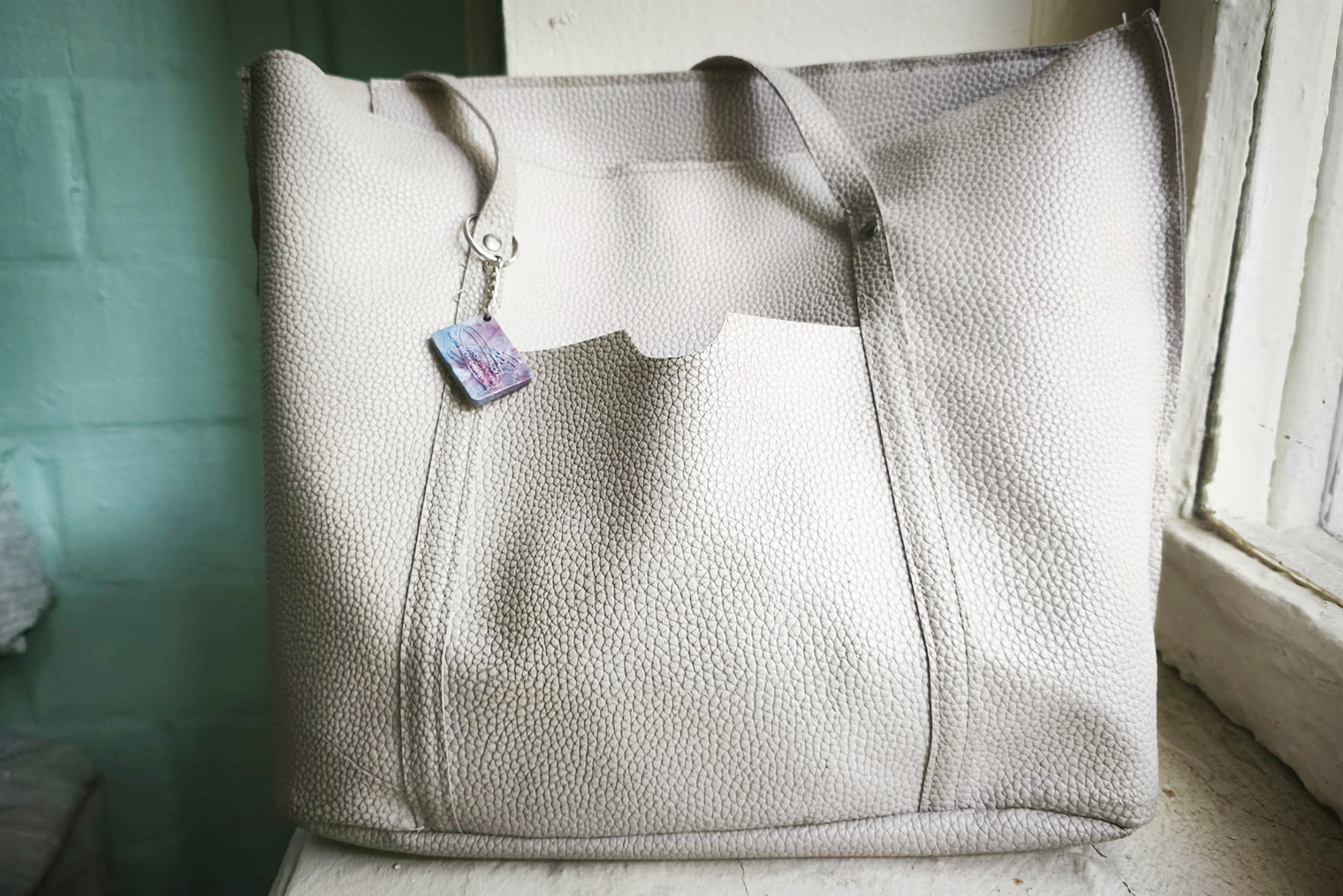 К своей сумке, в которую кладу мешок на обратном пути, я прикрепила брелок — он сделан из переработанных крышечек под прессом. Так сувенир концептуально подошел моим экологичным «походам»