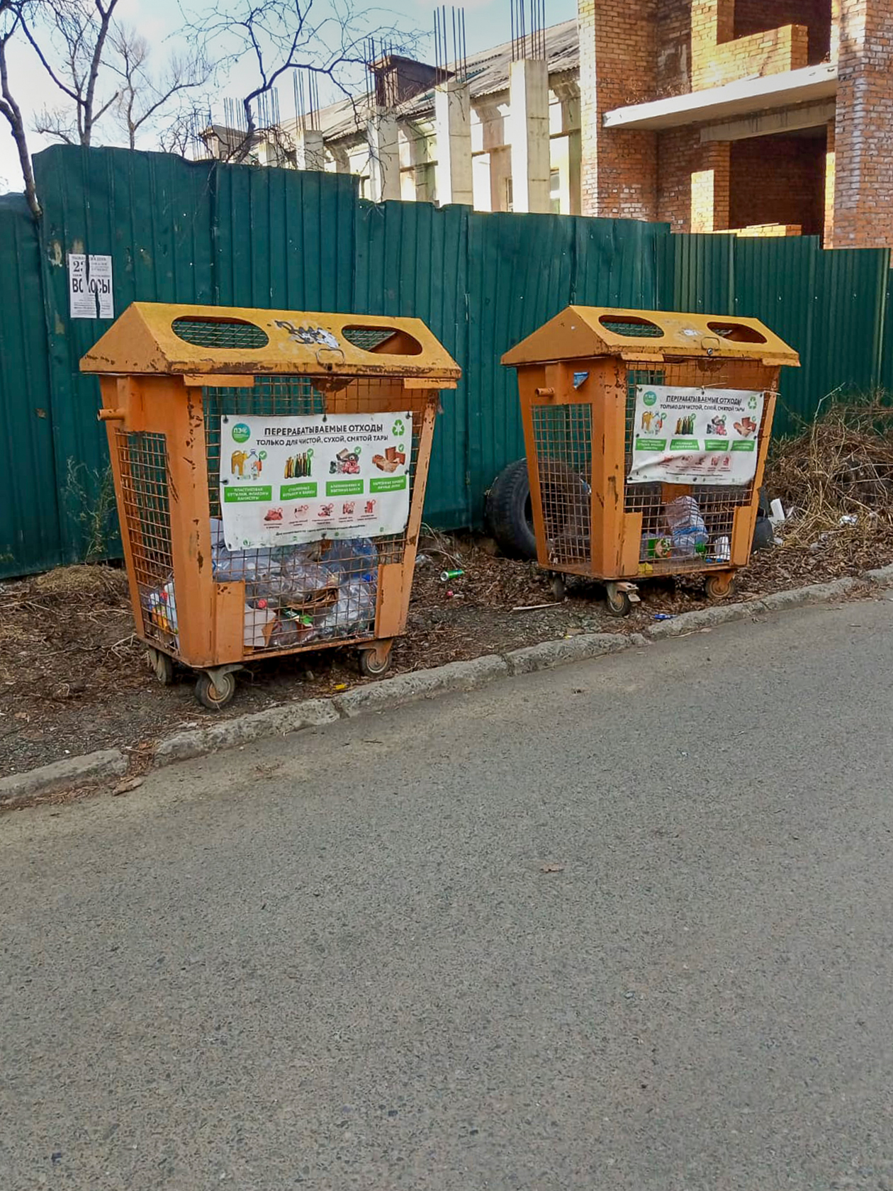 Два оранжевых контейнера для вторсырья во дворе