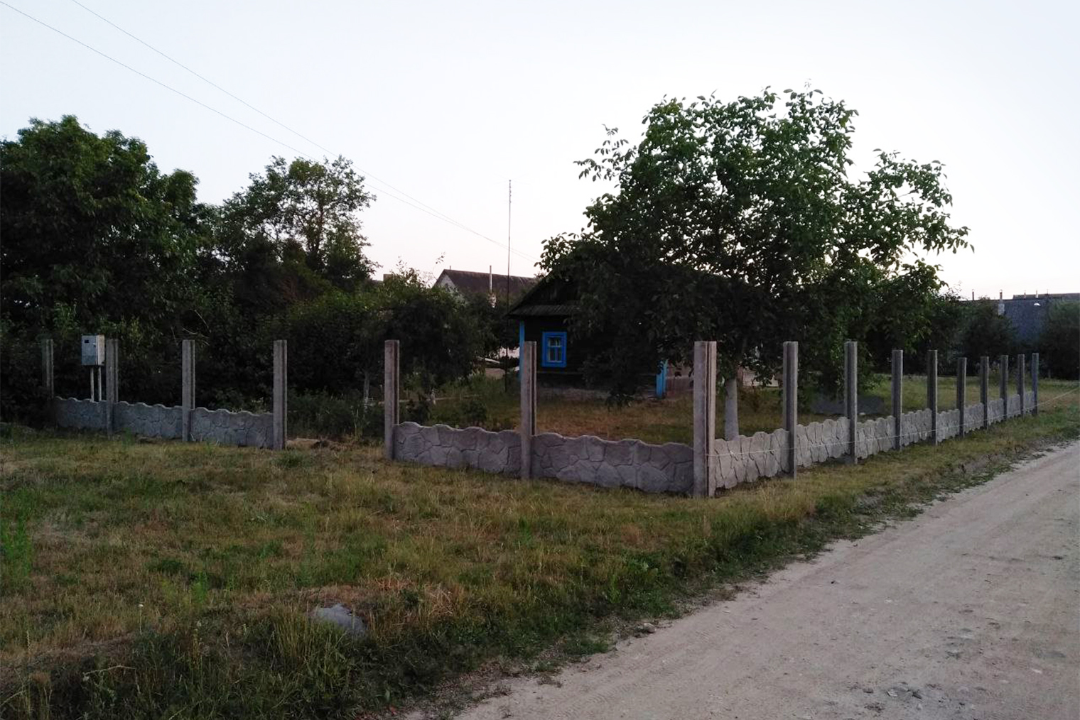 Новый забор бетонный и состоит из длинных плит, которые ставили одну на другую. Здесь пока готов только первый ряд