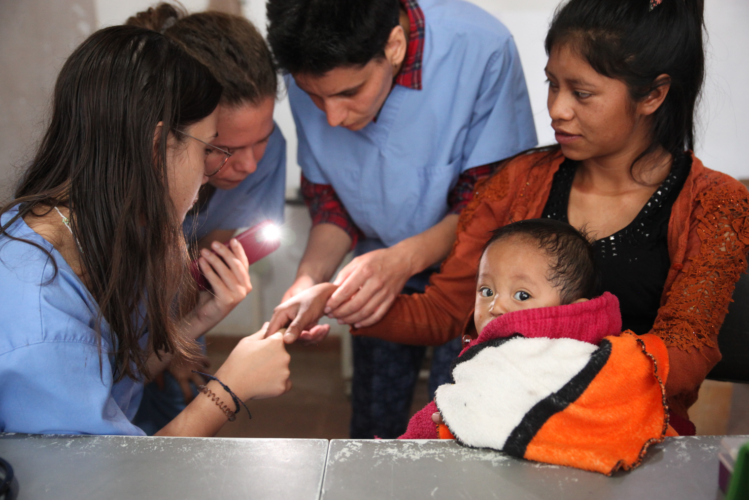 Врачи осматривают пациентку в клинике в Гватемале