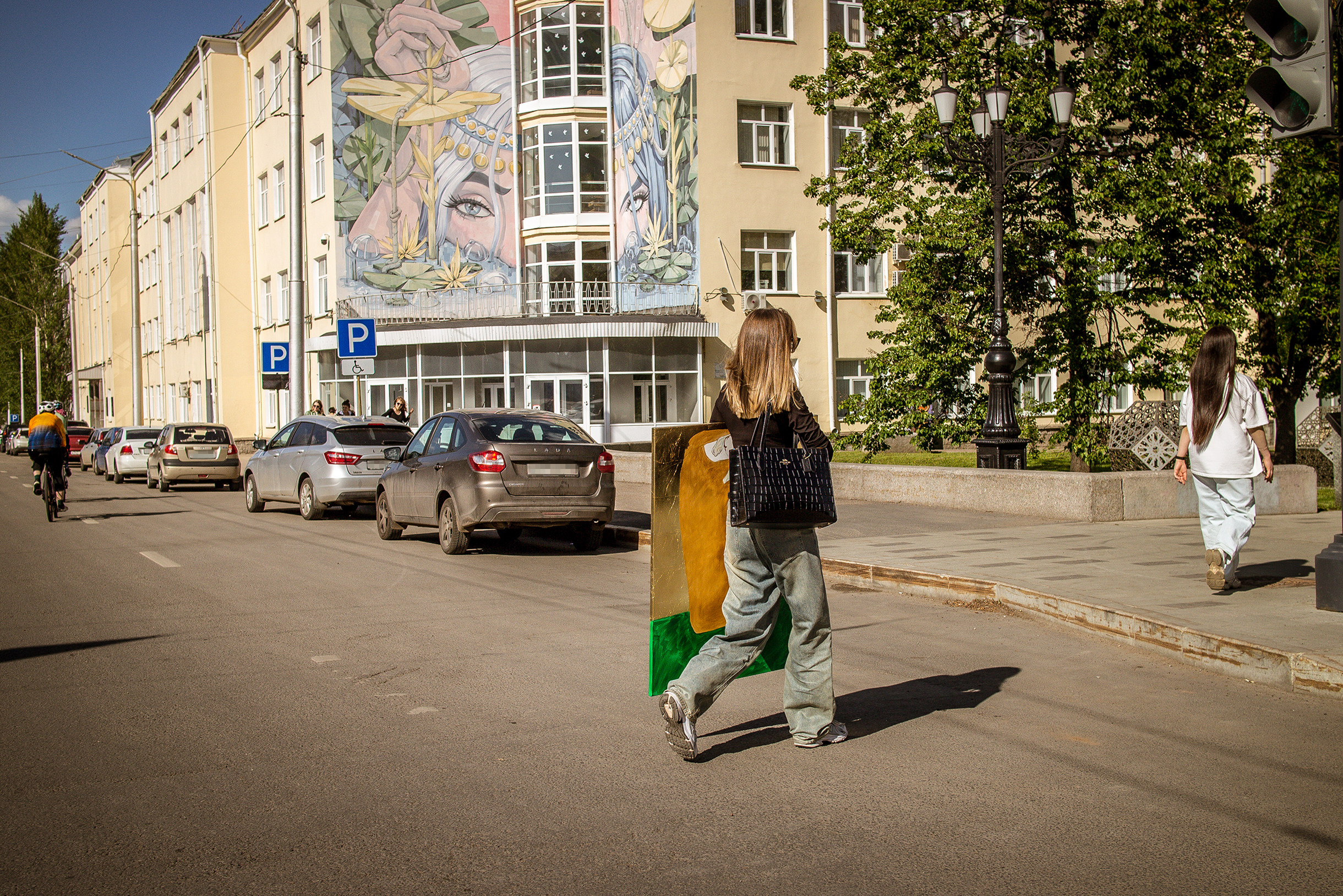 Мурал в стиле японской манги «Идель» на фасаде авиационного университета на заднем плане и девушка, что коня на скаку остановит и в горящую избу войдет, — на переднем. Уфу расписывали художники со всей России — как известные, так и начинающие. Местные мастера тоже отметились — как без них