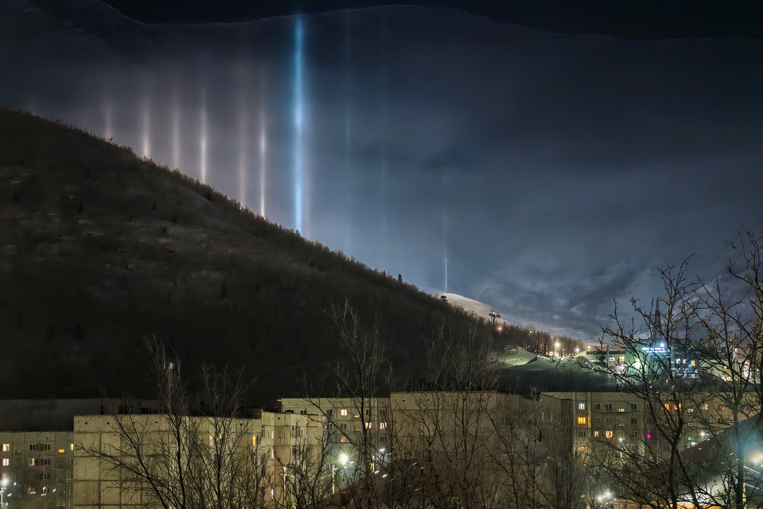 Не знаю, что это за явление, но удивительные столбы я заметила в день с низкой облачностью. Сняла из окна отеля на Парковой улице