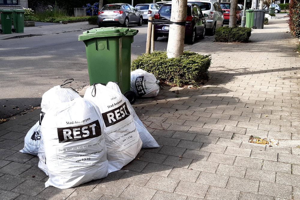Отсортированные отходы дожидаются, когда сборщики их заберут. Белые мешки — это общий мусор, зеленые контейнеры — для органических отходов