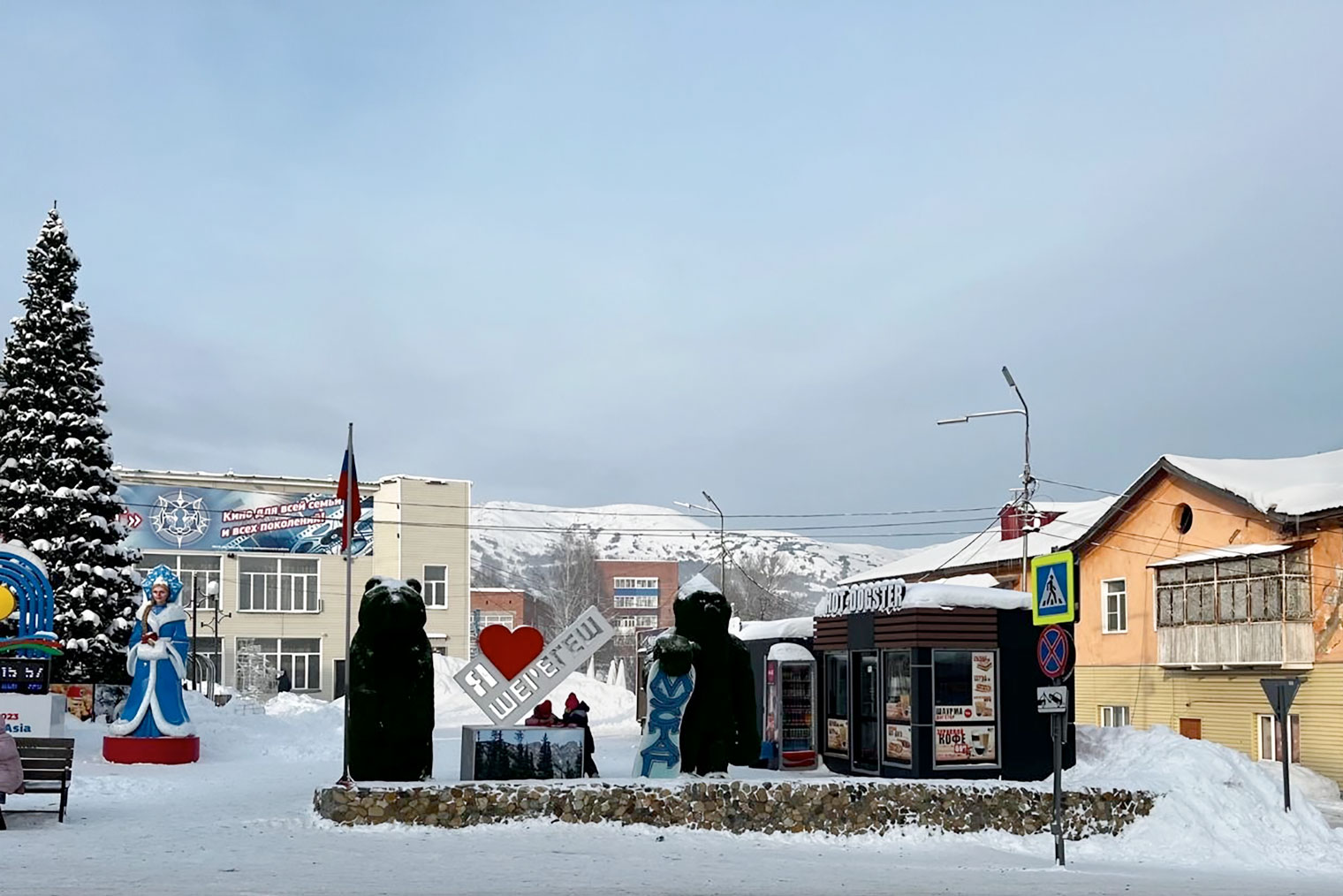 Главная площадь поселка Шерегеш, из⁠-⁠за елки выглядывает кинотеатр «Мустаг»