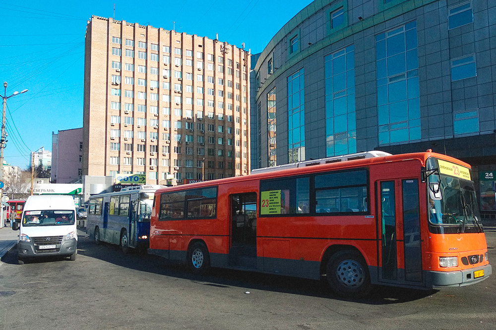 Справа — корейский автобус марки «Дэу», олицетворение общественного транспорта Владивостока в девяностых и начале нулевых. Сейчас «корейцев» почти вытеснили русские «газели» — пошлины на ввоз авто подняли и ввозить подержанные автобусы стало невыгодно
