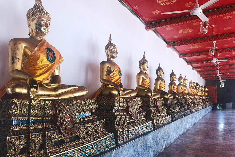 По периметру храма расставлены сотни разных статуй Будды, которые привезли из северных провинций Таиланда
