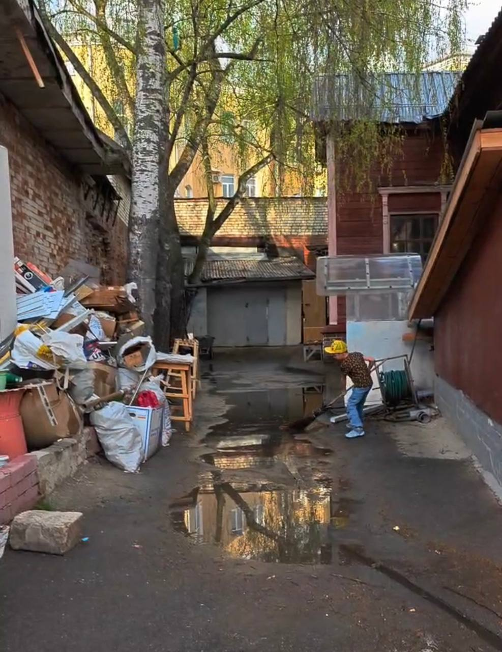 Это наш младший сын участвует в общем деле. Пока рабочие выносили мусор после демонтажа — он сгонял воду со двора метлой. Сейчас после проведенных работ, конечно, дела обстоят намного лучше.