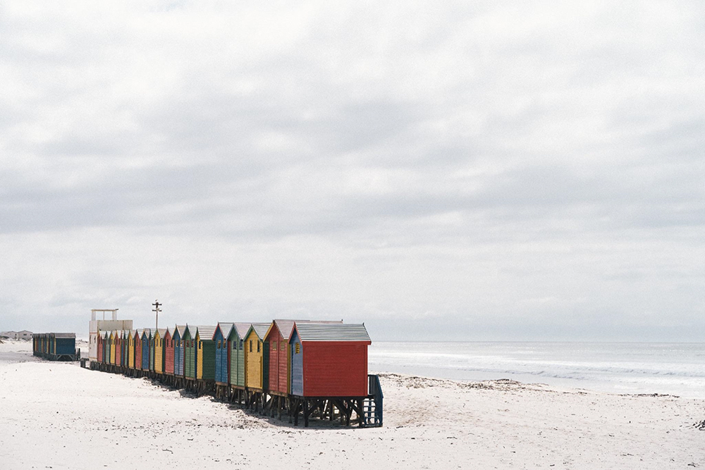 Пляж Муйзенберг в Кейптауне. Из⁠-⁠за пандемии нас не пустили к этим старым серферским домикам, я сфотографировала их издалека. Местные серферские школы хранят в них оборудование