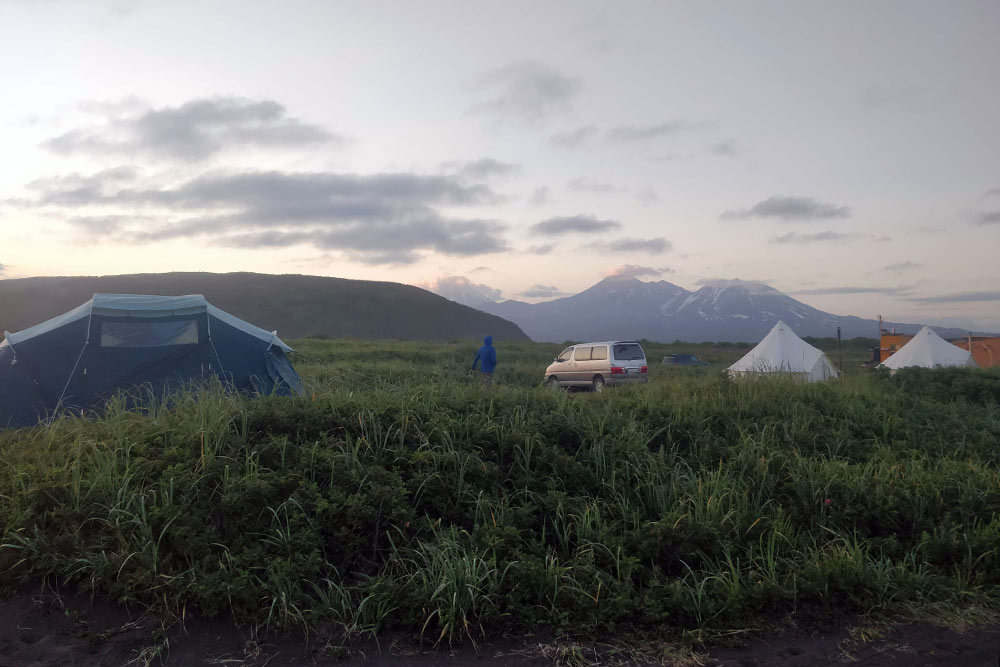 Слева — одна из наших палаток, справа — шатры глэмпинга. На заднем плане — Авачинская сопка и Козельский вулкан